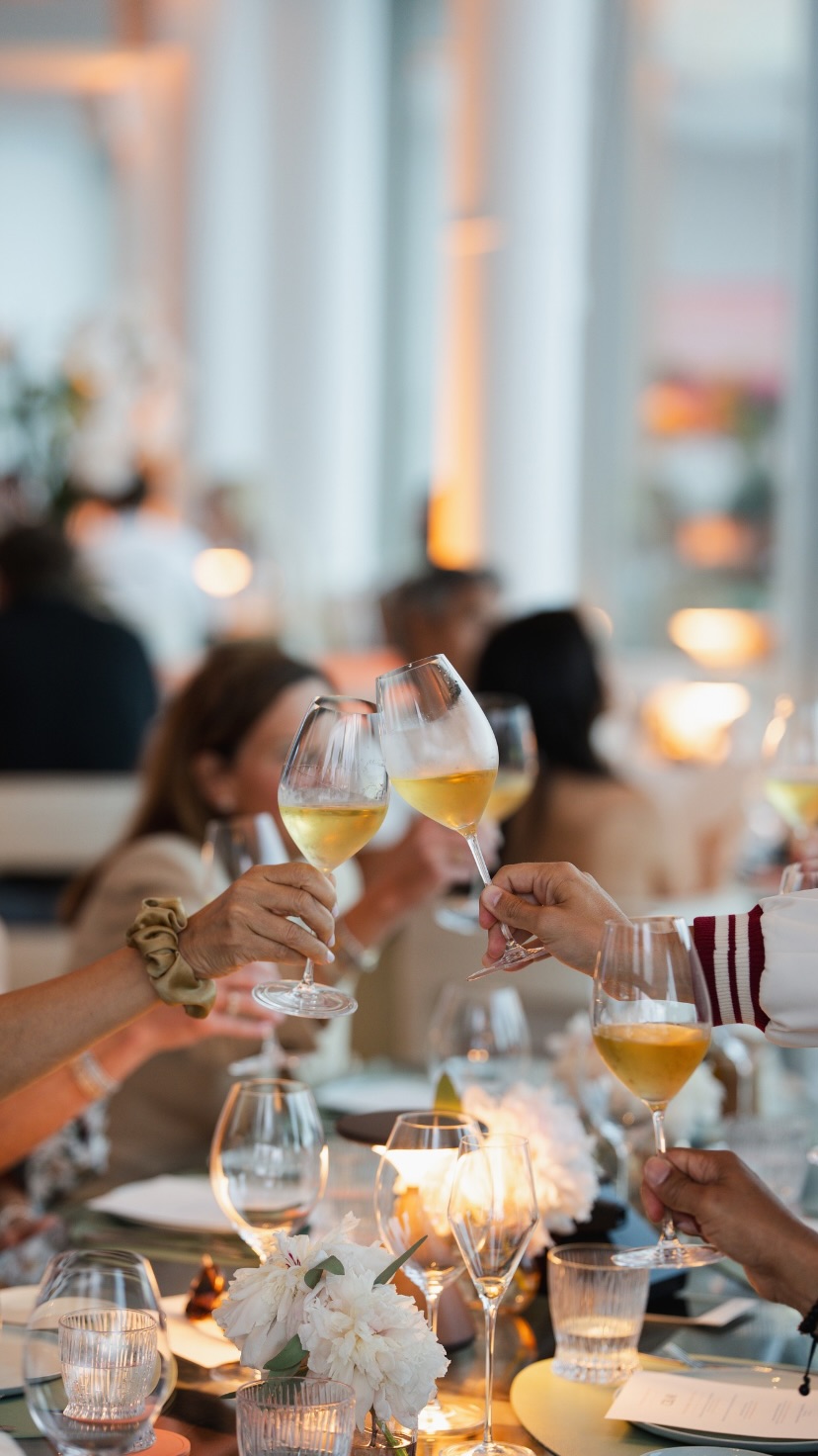 A shared toast around an elegantly set dinner table