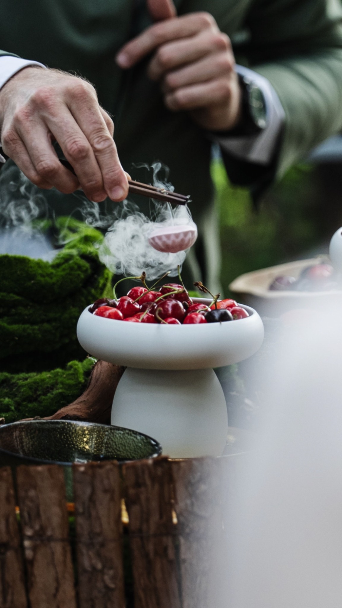 Detailed tableside culinary service with a small plated preparation