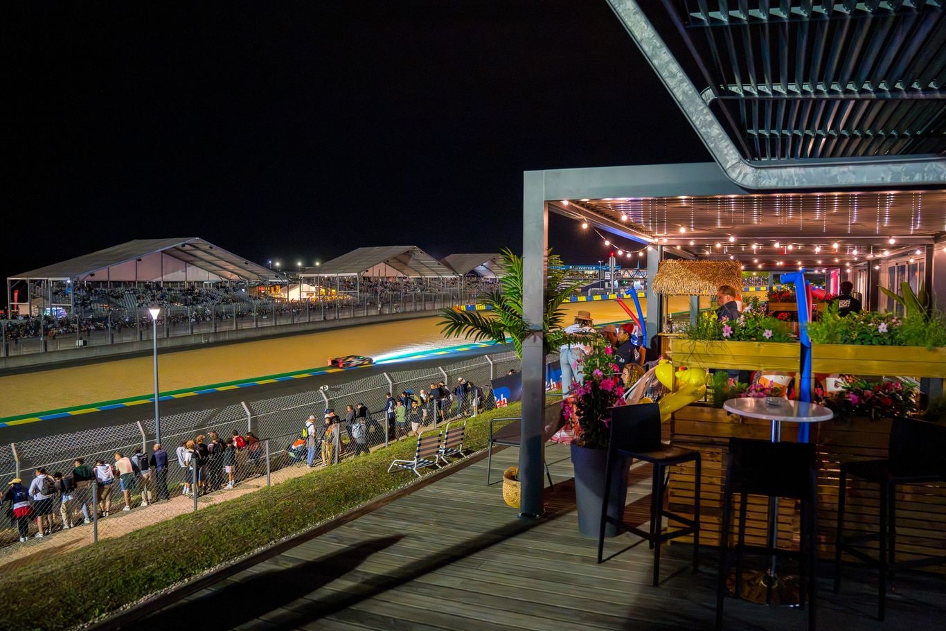 A private terrace overlooking Le Mans at night